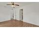 Spacious bedroom with hardwood floors, ceiling fan, and multiple entryways at 5875 Darren N Ct, Clearwater, FL 33760