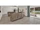 Open-concept living area with tile flooring, neutral paint, and access to the backyard through sliding glass doors at 5875 Darren N Ct, Clearwater, FL 33760