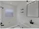 Bright bathroom featuring all-white tiling, modern fixtures, and a sleek vanity at 6120 5Th N Ave, St Petersburg, FL 33710