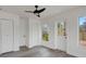 Bedroom with neutral paint, ceiling fan, closet and door to the backyard at 6120 5Th N Ave, St Petersburg, FL 33710