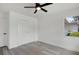 Bedroom features hardwood flooring, ceiling fan, and large closet for storage at 6120 5Th N Ave, St Petersburg, FL 33710