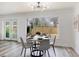 Dining room with contemporary chandelier, stylish table set and bright window at 6120 5Th N Ave, St Petersburg, FL 33710