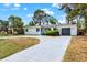Beautiful single-story home with a gray driveway, lush landscaping, and a sleek gray garage door at 6120 5Th N Ave, St Petersburg, FL 33710