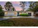 Charming single-story home featuring a gray driveway, minimalist landscaping and stylish blue door at 6120 5Th N Ave, St Petersburg, FL 33710