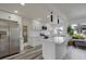 Well-lit modern kitchen with stainless steel appliances, white cabinetry and gray wood-style floors at 6120 5Th N Ave, St Petersburg, FL 33710