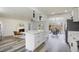Open concept kitchen with white cabinets and island overlooking the living room, perfect for entertaining at 6120 5Th N Ave, St Petersburg, FL 33710
