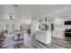 Open concept living space with modern white cabinets, stainless appliances, and stylish decor at 6120 5Th N Ave, St Petersburg, FL 33710