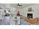 Open-concept living room features a cozy fireplace, leather chairs and hardwood floors at 6120 5Th N Ave, St Petersburg, FL 33710