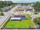 Aerial view of a home with solar panels, screened in porch and large fenced-in yard at 6246 Bandura Ave, New Port Richey, FL 34653