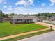 Aerial shot of a well-kept home with a green lawn and driveway at 6246 Bandura Ave, New Port Richey, FL 34653