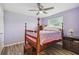 Bedroom with wood-look floors, a ceiling fan, and a traditional wood bed frame at 6246 Bandura Ave, New Port Richey, FL 34653