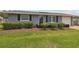 Charming single-story home with a manicured lawn, flowering bushes, and a one-car garage at 6246 Bandura Ave, New Port Richey, FL 34653