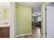 Inviting hallway leads to a living room with wood-look flooring and soft green walls at 6246 Bandura Ave, New Port Richey, FL 34653