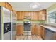 Kitchen featuring stainless steel appliances, granite countertops, and wood cabinets at 6246 Bandura Ave, New Port Richey, FL 34653