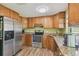 Kitchen featuring stainless steel appliances, granite countertops, and wood cabinets at 6246 Bandura Ave, New Port Richey, FL 34653