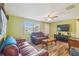 Bright living room with ceiling fan, comfortable seating, and large window at 6246 Bandura Ave, New Port Richey, FL 34653