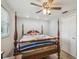 Comfortable main bedroom with ceiling fan, four-poster bed, and natural light at 6246 Bandura Ave, New Port Richey, FL 34653