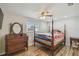 Spacious main bedroom features a four-poster bed and light-filled window at 6246 Bandura Ave, New Port Richey, FL 34653
