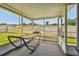 Serene screened porch features a comfortable hammock and view of fenced backyard at 6246 Bandura Ave, New Port Richey, FL 34653