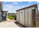 Backyard storage shed with a peaked roof, next to a fenced lawn at 6246 Bandura Ave, New Port Richey, FL 34653