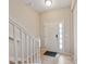 Foyer view showcases a white front door with glass inserts, tile floors, and stair access at 6912 40Th N Ln, Pinellas Park, FL 33781