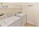 Laundry room features a washer, dryer, and shelving at 6912 40Th N Ln, Pinellas Park, FL 33781