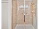 Tile shower with glass door and grab bar for assistance at 6912 40Th N Ln, Pinellas Park, FL 33781