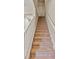 Carpeted staircase featuring white banister and handrail leading to upper level at 6912 40Th N Ln, Pinellas Park, FL 33781