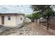 Spacious backyard featuring grass, shed, a wooden fence, and trees at 7012 Pin Cherry Ln, Port Richey, FL 34668