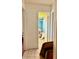 Hallway shot revealing a bathroom with a blue tiled shower in need of decluttering at 7012 Pin Cherry Ln, Port Richey, FL 34668