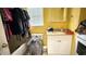 A yellow bathroom with a sink, toilet, and tub/shower combination behind a pile of clothes at 7012 Pin Cherry Ln, Port Richey, FL 34668
