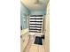 Bright bathroom featuring blue walls, white vanity and sink, and shower with striped curtain at 7012 Pin Cherry Ln, Port Richey, FL 34668