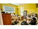 Bedroom featuring yellow walls and a window, filled with personal belongings and furniture at 7012 Pin Cherry Ln, Port Richey, FL 34668