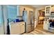 Bright kitchen featuring stainless steel appliances, ample cabinet space, and wood-look flooring at 7012 Pin Cherry Ln, Port Richey, FL 34668