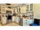 Bright kitchen featuring stainless steel appliances, white cabinetry, and a stone backsplash at 7012 Pin Cherry Ln, Port Richey, FL 34668