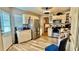 Bright kitchen featuring stainless steel appliances, ample cabinet space, and wood-look flooring at 7012 Pin Cherry Ln, Port Richey, FL 34668