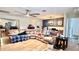 Spacious living room features ceiling fan, wood floors, adjacent to dining area at 7012 Pin Cherry Ln, Port Richey, FL 34668