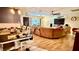 Spacious living room featuring an open floor plan, hardwood floors, and a ceiling fan at 7012 Pin Cherry Ln, Port Richey, FL 34668