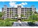 Beautiful multi-story condo building with lush landscaping and ample parking, perfect for luxury living at 7069 Key Haven Rd # 602, Seminole, FL 33777