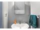 Bathroom with a white sink, framed mirror, towel bar, and orange soap dispenser at 7606 Woodbridge Blvd, Tampa, FL 33615