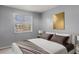 Bright bedroom featuring a large window and modern decor with gold accents at 7606 Woodbridge Blvd, Tampa, FL 33615