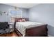 Cozy bedroom featuring a wood sleigh bed, desk, and bright natural light at 7606 Woodbridge Blvd, Tampa, FL 33615