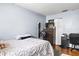 This bedroom features wood floors, a closet, and stylish furniture at 7606 Woodbridge Blvd, Tampa, FL 33615