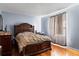 This bedroom features a large, ornate wooden bed and wood floors at 7606 Woodbridge Blvd, Tampa, FL 33615