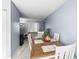 Open concept dining area with tile floors and view into the living area at 7606 Woodbridge Blvd, Tampa, FL 33615