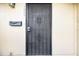 Close-up of the front door entrance with security gate and vintage mail box at 7606 Woodbridge Blvd, Tampa, FL 33615
