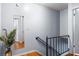 Hallway featuring wood floors, stairs, and a mirror at 7606 Woodbridge Blvd, Tampa, FL 33615