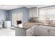 Kitchen featuring granite counters and white cabinets, with stainless appliances at 7606 Woodbridge Blvd, Tampa, FL 33615