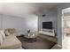 Spacious living room with couch, media center, and a view into the kitchen at 7606 Woodbridge Blvd, Tampa, FL 33615