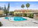 The community pool is surrounded by landscaping and condominiums, offering a serene oasis for residents at 7606 Woodbridge Blvd, Tampa, FL 33615
